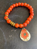 Orange Glass and Gold Bead and Floral Tin Charm Bracelet